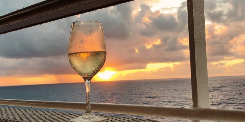 glass of wine at sunset best adult cruises